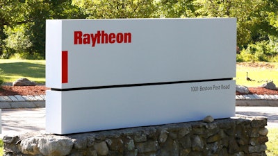 A sign stands at the road leading to the Raytheon facility.