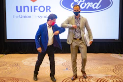 Unifor President Jerry Dias, left, elbow-bumps Ryan Kantautas, vice president of human resources at Ford Canada, at the start of formal contract talks with the Detroit Three automakers, Toronto, Aug. 12, 2020.
