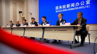 Chinese health officials attend a press conference held to discuss COVID-19 vaccine-related issue.