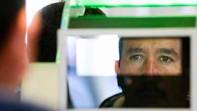 A pedestrian crossing from Mexico into the U.S. has his facial features and eyes scanned at a biometric kiosk, Otay Mesa Port of Entry, San Diego, Dec. 10, 2015.