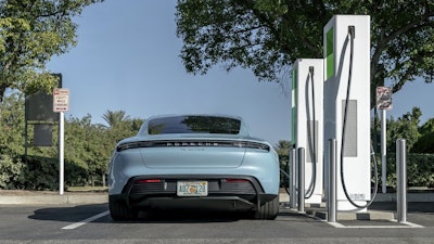 A 2020 Porsche Taycan at a public charging station.