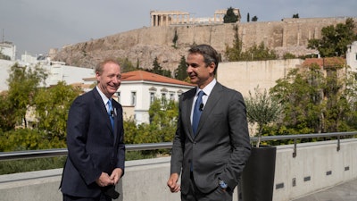 Microsoft President Brad Smith, left, speaks with Greek Prime Minister Kyriakos Mitsotakis during a ceremony in the Acropolis Museum, Athens, Oct. 5, 2020.