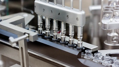 Rubber stoppers are placed onto filled vials of the investigational drug remdesivir at a Gilead U.S. manufacturing site, March 2020.
