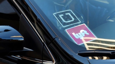 Ride-share car displaying Lyft and Uber stickers, Los Angeles, Jan. 12, 2016.