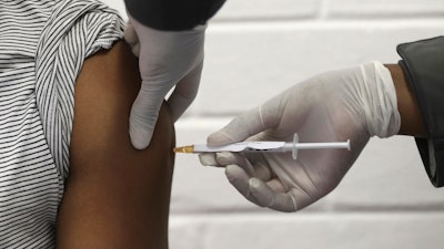 A volunteer receives an injection at the Chris Hani Baragwanath hospital in Soweto, Johannesburg, June 24, 2020.