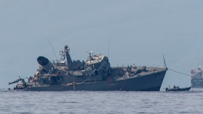 Α damaged navy minesweeper towed near the port of Piraeus, Oct. 27, 2020.
