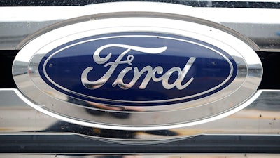 In this Oct. 20, 2019, file photograph, the company logo shines off the grille of an unsold 2019 F-250 pickup truck at a Ford dealership in Littleton, Colo. Ford Motor Co. posted a stronger-than-expected third-quarter net profit, the company announced Wednesday, Oct. 28, 2020, as demand for cars and trucks recovered from coronavirus shutdowns and the company sold more high-margin trucks.