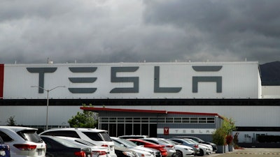This May 12, 2020 file photo photo shows the Tesla plant in Fremont, Calif. Tesla’s third-quarter sales rose 44% from a year ago as global demand for its electric vehicles proved stronger than most other automakers. The company said it delivered 139,000 SUVs and sedans from July through September compared with 97,000 deliveries during the same period a year ago.