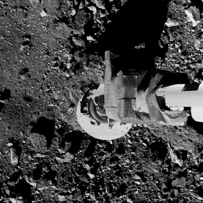 This image shows the OSIRIS-REx spacecraft’s sampling arm – called the Touch-And-Go Sample Acquisition Mechanism (TAGSAM) – and asteroid Bennu during the mission’s checkpoint rehearsal.