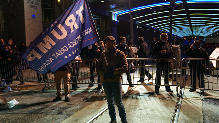 A Trump supporter stands outside the Pennsylvania Convention Center, Nov. 5, 2020.