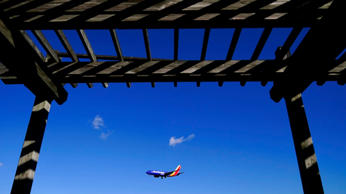 A shelter is seen at the Thomas Dixon Aircraft Observation Area as a Southwest Airlines flight from Jacksonville, Fla., makes its landing approach onto Baltimore-Washington International Thurgood Marshall Airport, Monday, Nov. 23, 2020, in Glen Burnie, Md. With coronavirus cases spiking in the U.S. and Europe, the financial outlook of the world's airlines is getting worse. The International Air Transport Association said Tuesday that around the world, airlines will lose more than $157 billion this year and next.