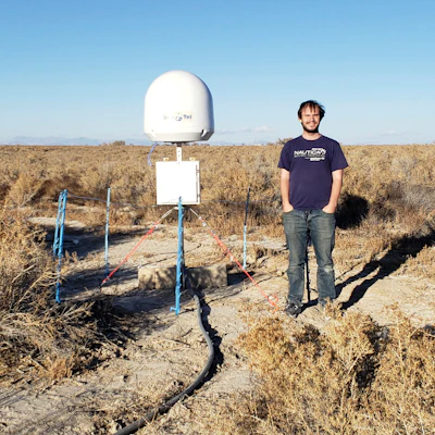 Radio astronomer Christopher Bochenek with a STARE2 station he developed near the town of Delta, Utah.