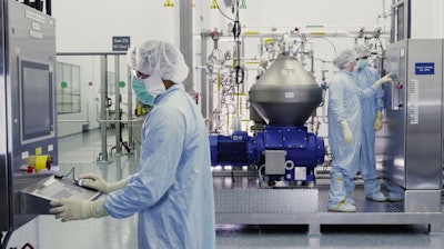 Scientists work with a bioreactor at a Regeneron Pharmaceuticals facility in New York state.