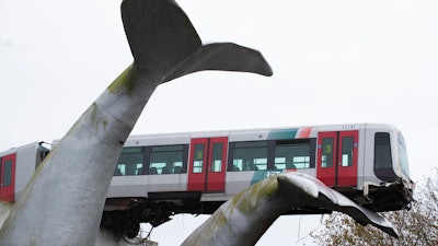 The front carriage of a metro train perched on a whale sculpture after ramming through the end of an elevated rail section, Spijkenisse, Netherlands, Nov. 2, 2020.