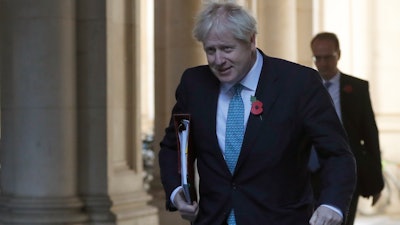Britain's Prime Minister Boris Johnson walks back towards 10 Downing Street following a cabinet meeting in London, Nov. 3, 2020.