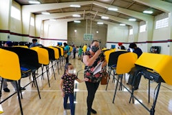 East Los Angeles voter Laura Cortez, 54, with her granddaughter Daniela 6, walk after casting her ballot in-person on Election Day.