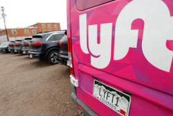 Kia Neros that are part of the Lyft ride-hailing fleet sit in a lot near Empower Field at Mile High in Denver, April 30, 2020.