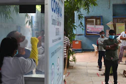 A health worker takes a nasal swab sample at a COVID-19 testing center in Hyderabad, India, Nov. 12, 2020.