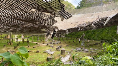 A 100-foot gash, created by a broken cable and metal platform, in the radio telescope's reflector dish in Arecibo, Puerto Rico, Aug. 11, 2020.