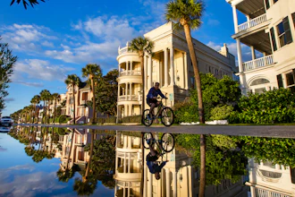 A bicyclist makes his way down East Battery as a king tide rolls into the historic Battery, Charleston, S.C., Nov. 15, 2020.