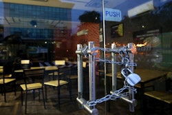 The entrance of an eatery is locked after it closed down due to pandemic in Bengaluru, India, Oct. 11, 2020.