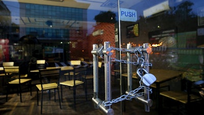 The entrance of an eatery is locked after it closed down due to pandemic in Bengaluru, India, Oct. 11, 2020.