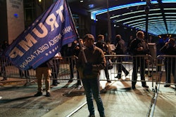 A Trump supporter stands outside the Pennsylvania Convention Center, Nov. 5, 2020.