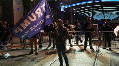 A Trump supporter stands outside the Pennsylvania Convention Center, Nov. 5, 2020.