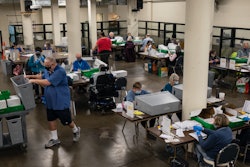 Election workers organize ballots at the Multnomah County Elections Division, Portland, Ore., Nov. 3, 2020.