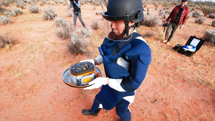 JAXA staff member retrieves a capsule dropped by Hayabusa2 in Woomera, Australia, Dec. 6, 2020.