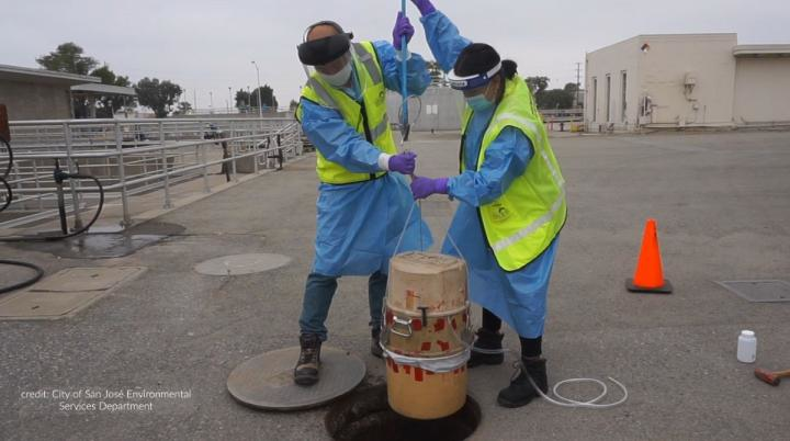 City of San Jos&eacute; Environmental Services Department's environmental inspectors Isaac Tam and Laila Mufty deploy an autosampler into a manhole at the San Jos&eacute; - Santa Clara Regional Wastewater Facility.