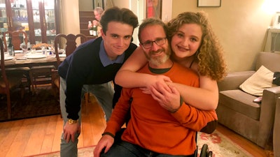 Samuel Kolb, seated, poses for a photo with his son Jacob and daughter Lexi in San Mateo, Calif., Nov. 2019.