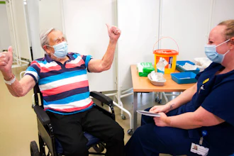 Henry (Jack) Vokes, 98, reacts receiving the Pfizer-BioNTech COVID-19 vaccine at Southmead Hospital, Bristol, England, Dec. 8, 2020.