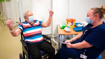 Henry (Jack) Vokes, 98, reacts receiving the Pfizer-BioNTech COVID-19 vaccine at Southmead Hospital, Bristol, England, Dec. 8, 2020.