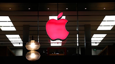 The Apple logo illuminated at a store, Munich, Dec. 6, 2020.