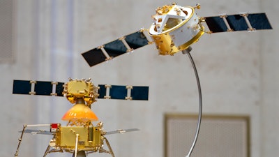 A model of China's Chang'e 5 lunar orbiter and lander displayed before a press conference at the State Council Information Office in Beijing, Dec. 17, 2020.