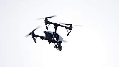 A drone flies in a residential neighborhood in Upper Moreland, Pa., Aug. 8, 2019.