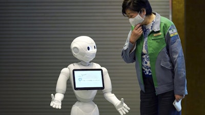 Humanoid robot Pepper greets Gov. Yuriko Koike in Tokyo, May 1, 2020.