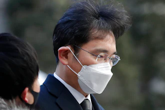 Samsung Electronics Vice Chairman Lee Jae-yong is questioned by a reporter upon arrival at the Seoul High Court in Seoul, South Korea, Dec. 30, 2020.