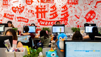 Workers at the headquarters of e-commerce platform Pinduoduo, Shanghai, July 25, 2018.