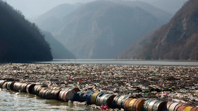 Plastic bottles, wooden planks, rusty barrels and other garbage clogging the Drina River near Visegrad, Bosnia, Jan. 5, 2021.