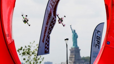 Pilots fly racing drones through an obstacle course for the National Drone Racing Championship, Governors Island, N.Y., Aug. 5, 2016.