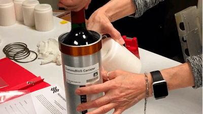 Researchers prepare bottles of French red wine to be flown from Wallops Island, Va., to the International Space Station, Nov. 2, 2019.