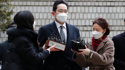 Samsung Electronics Vice Chairman Lee Jae-yong is questioned by reporters upon his arrival at the Seoul High Court, Jan. 18, 2021.