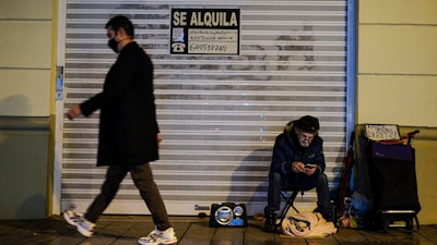 A homeless with his dog in Pamplona, Spain, Jan. 21, 2021.