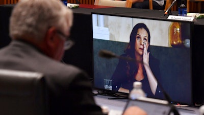 Mel Silva, right, managing director of Google Australia and New Zealand, appears via a video link during a Senate inquiry into a mandatory code of conduct, Parliament House, Canberra, Jan. 22, 2021.