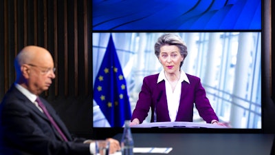 Klaus Schwab, left, executive chairman of the World Economic Forum, listens to European Commission President Ursula von der Leyen at the Davos Agenda in Cologny, Switzerland, Jan. 26, 2021.