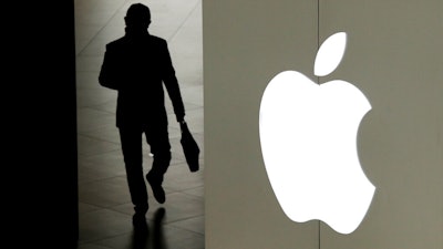 A man leaves an Apple store in Beijing, Jan. 3, 2019.