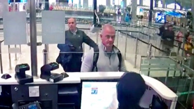 Image from security camera video showing Michael L. Taylor, center, and George-Antoine Zayek at passport control, Istanbul Airport, Dec. 30, 2019.