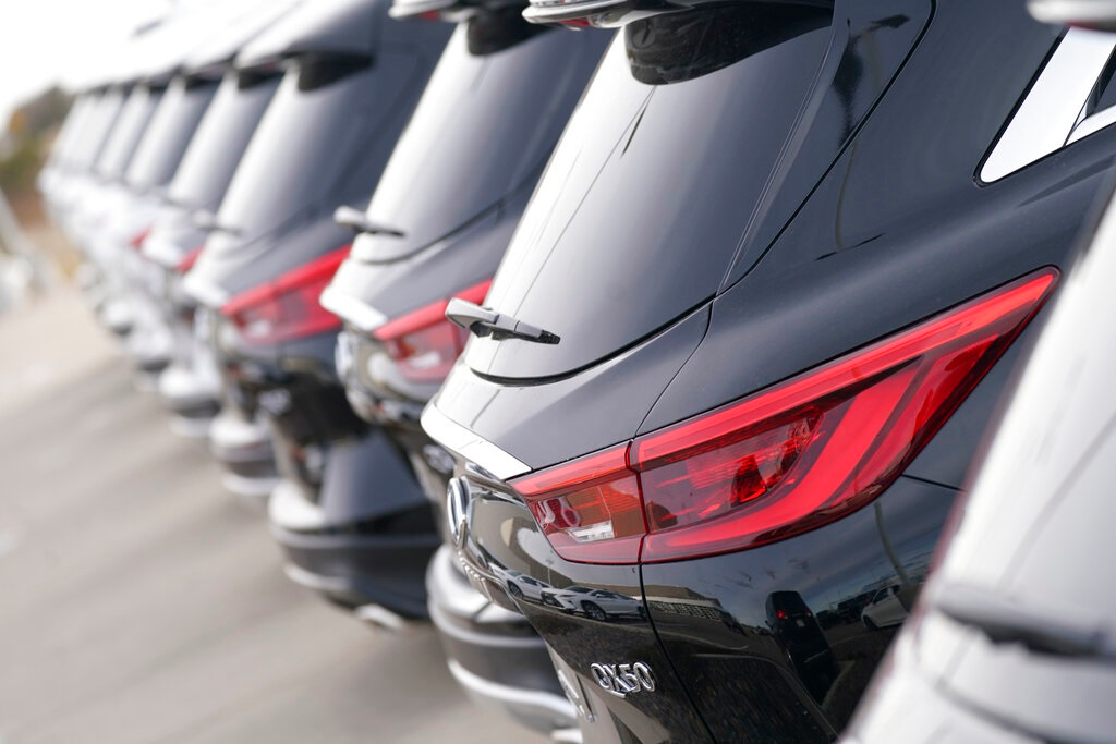 A long row of unsold 2021 QX50 sports-utility vehicles sits at an Infiniti dealership Sunday, Dec. 27, 2020, in Highlands Ranch, Colo. U.S. auto sales are expected to be down only about 15% for the year, with the average price hitting a record high as sales bounced back during the second half of the year.